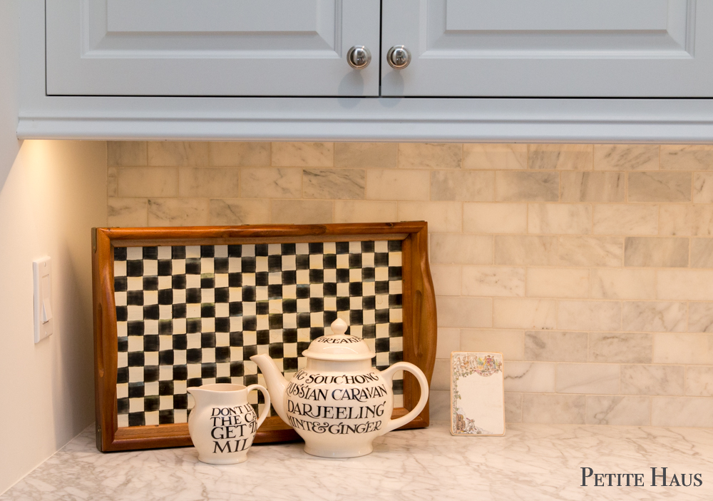 Coffee bar with farmhouse white kitchen cabinets and marble counters