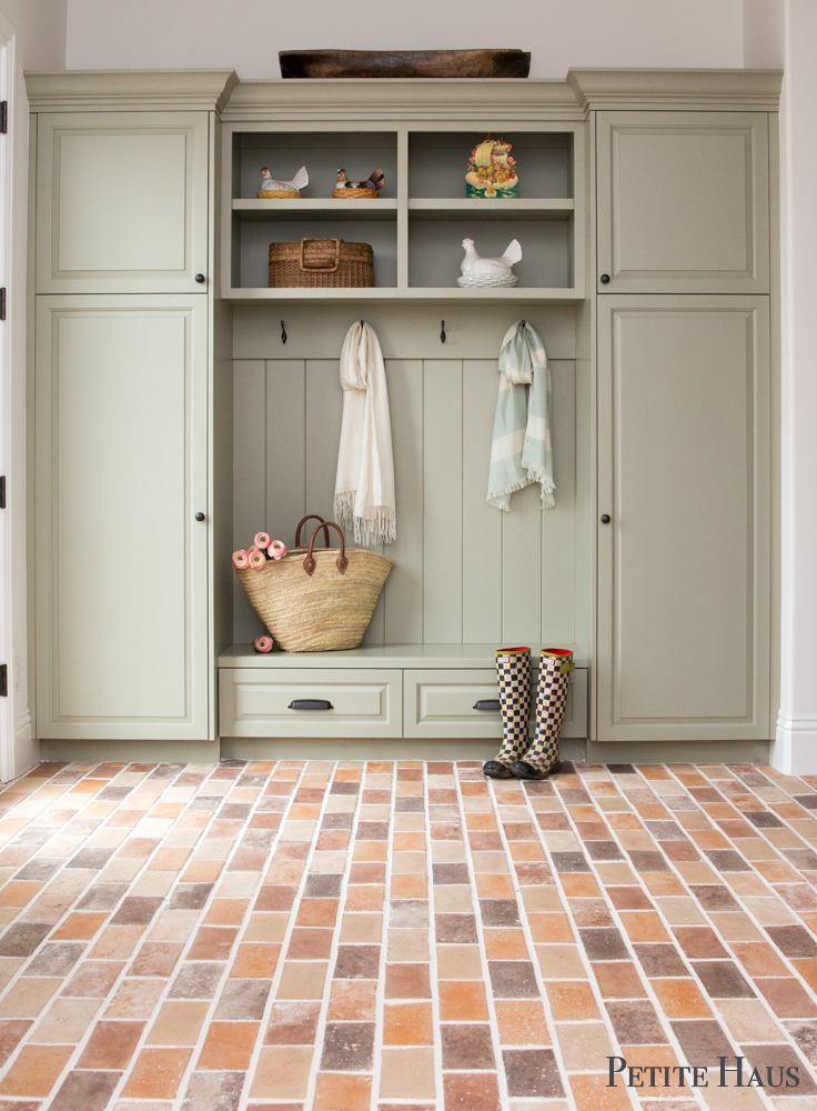 Farmhouse mudroom with brick floors