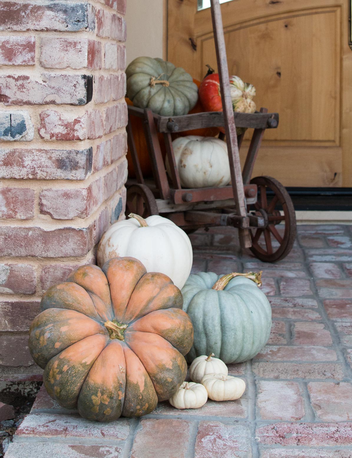 Fall porch decorating ideas with fairytale pumpkins and a goat cart