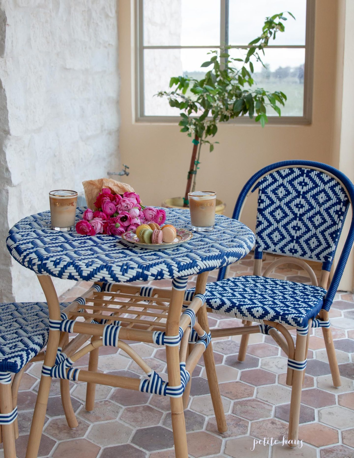 blue and white French bistro chairs on the porch