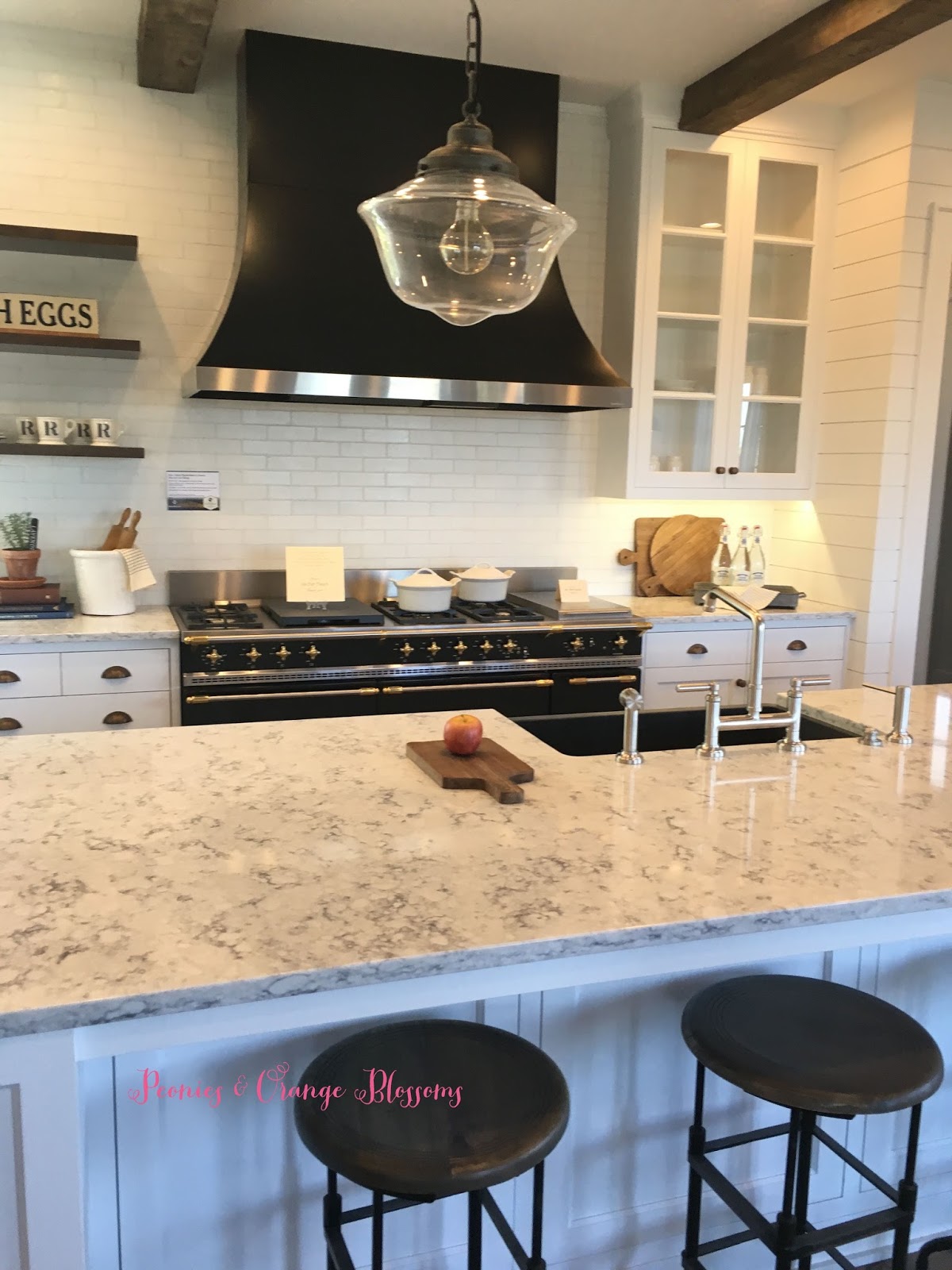 Touring a French farmhouse with brick backsplash and lacanche range